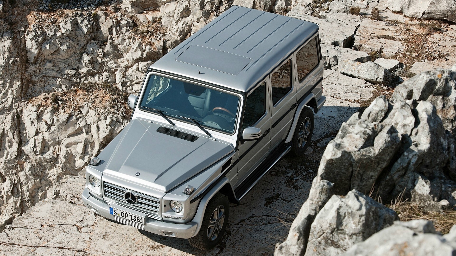 Silver G-Wagon on rocky terrain