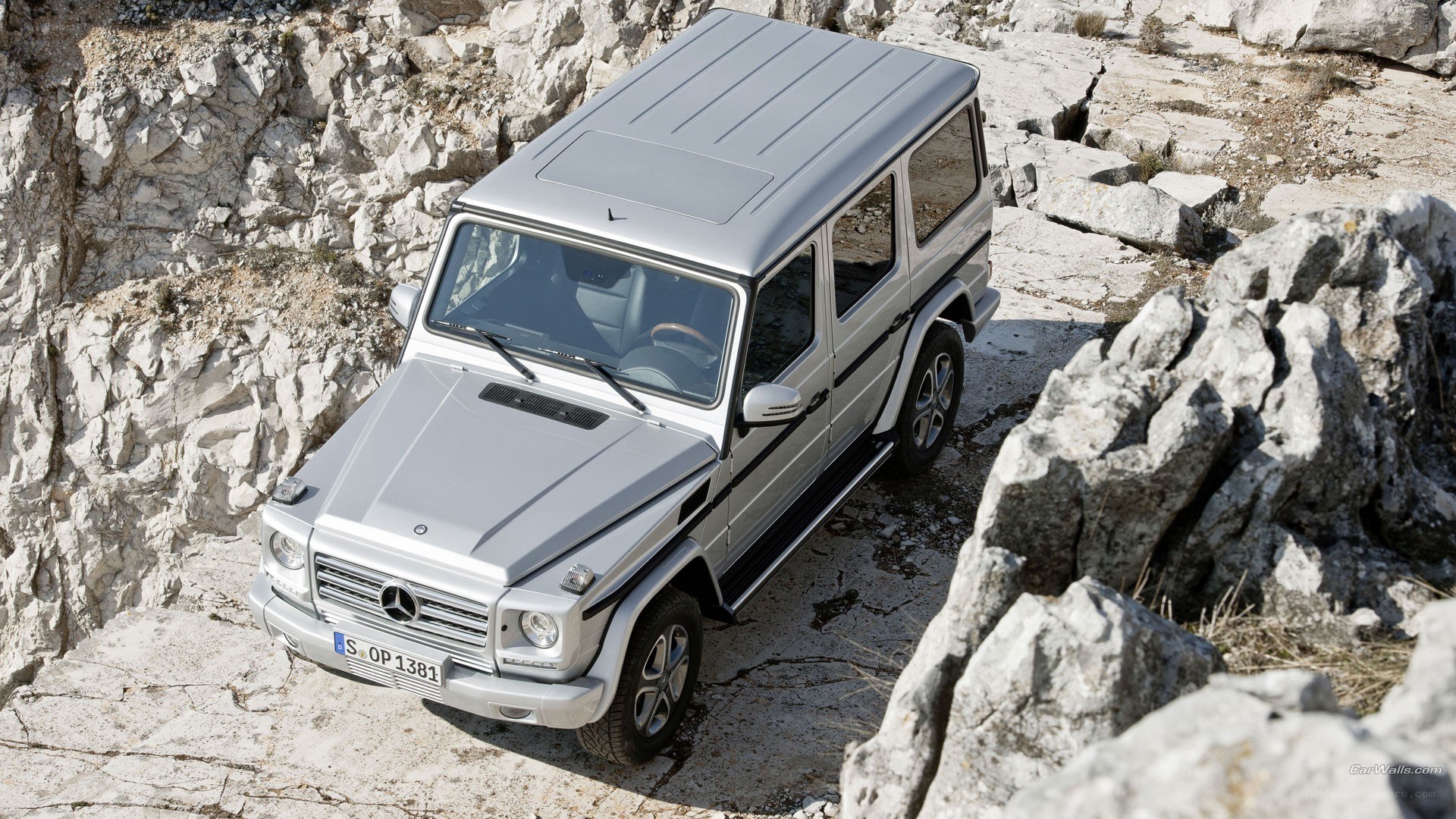 Silver G-Wagon on rocky terrain