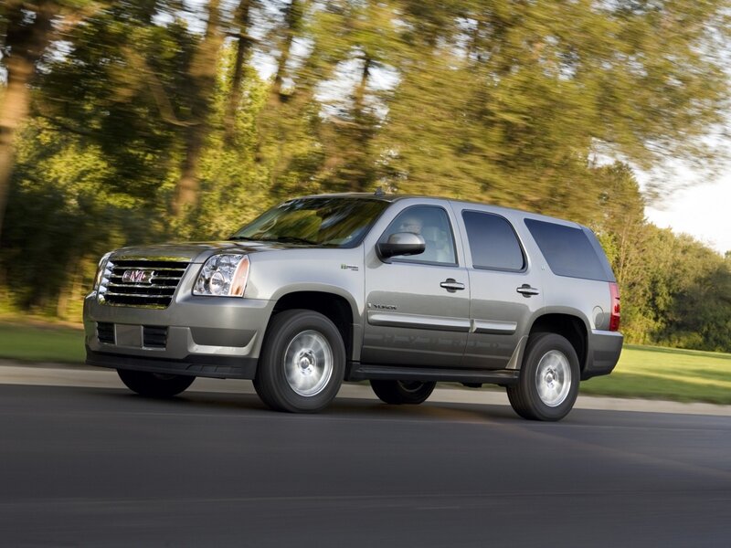 Silver GMC Yukon driving on road