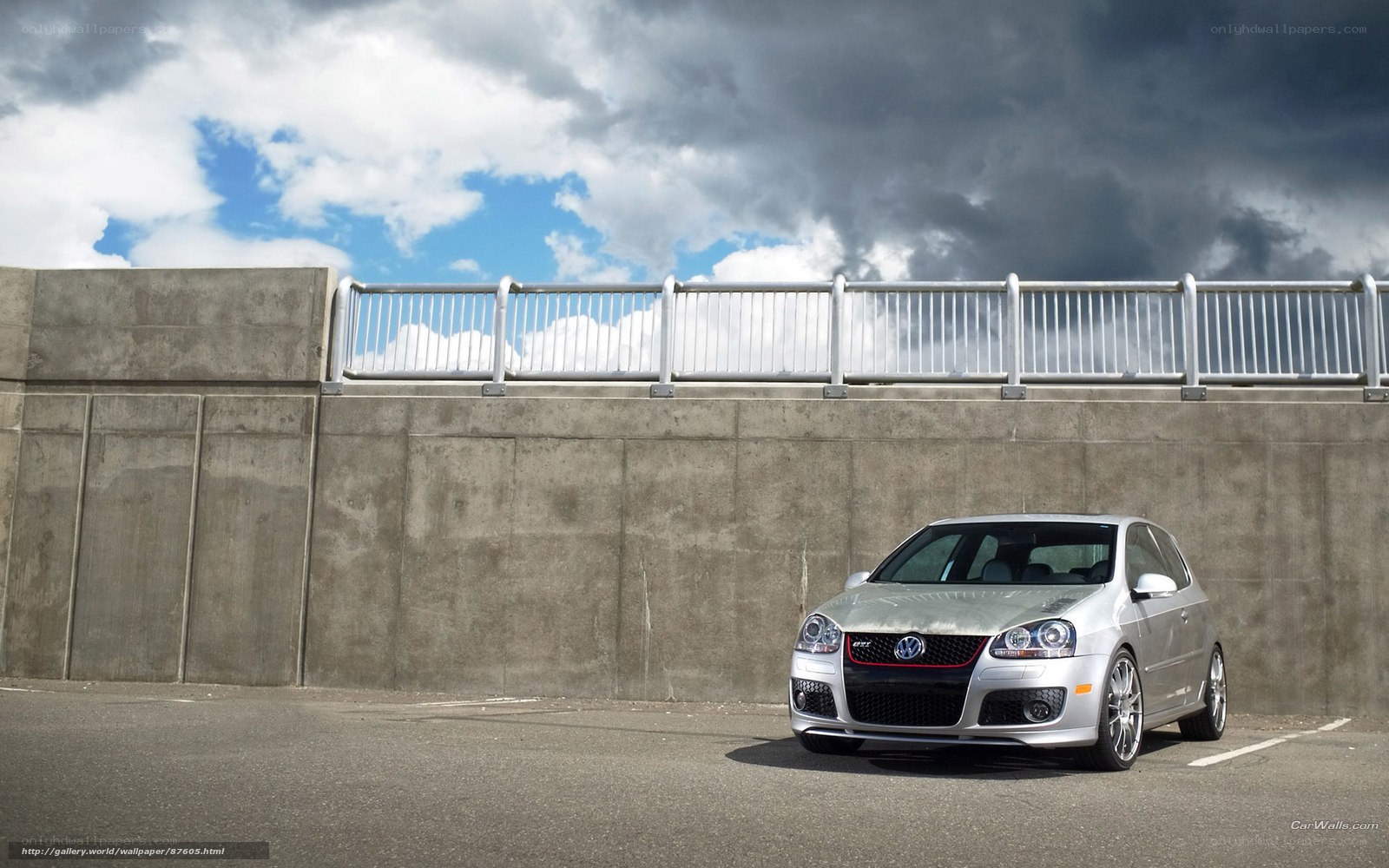 Silver GTI on concrete overpass