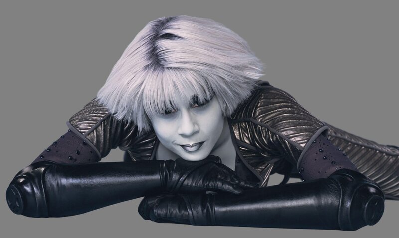 silver-haired performer in costume