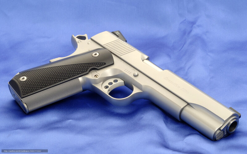 Silver Handgun on Blue Cloth — Neutral, Photograph