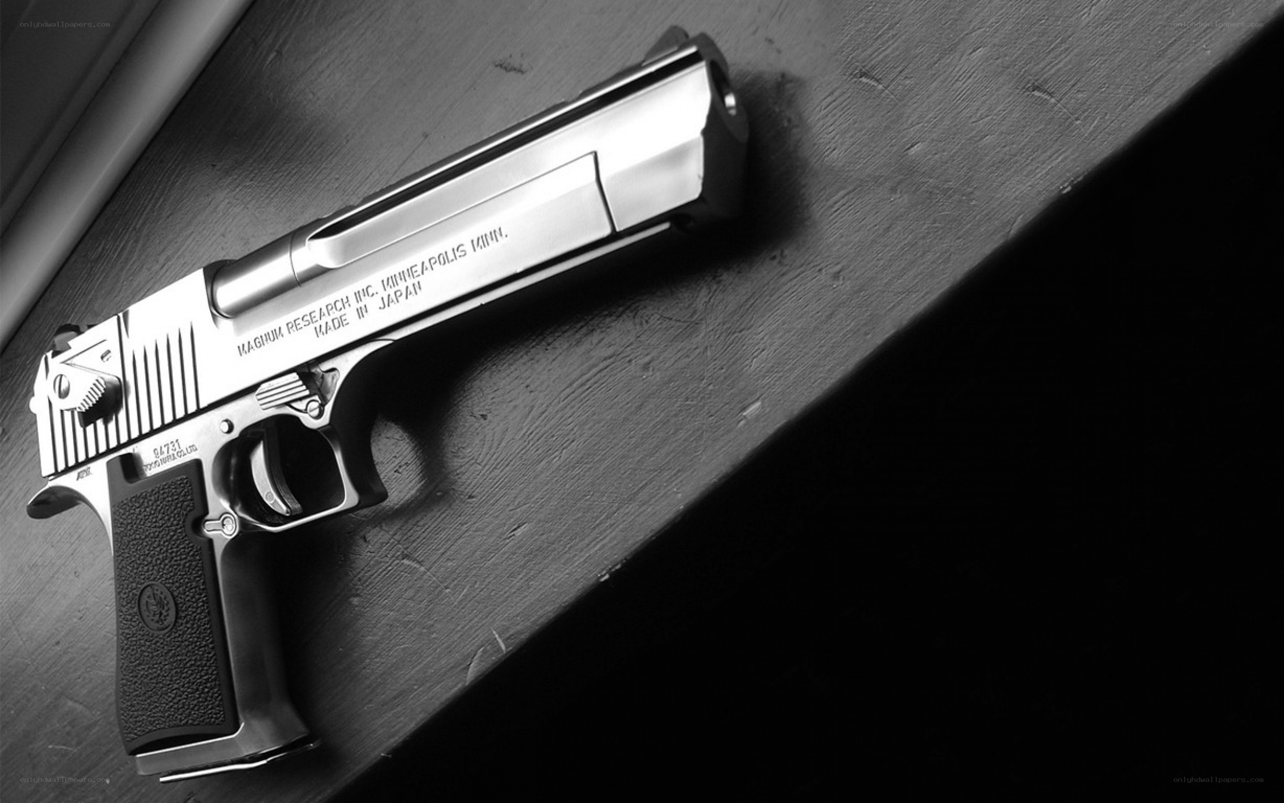 silver handgun on wooden surface