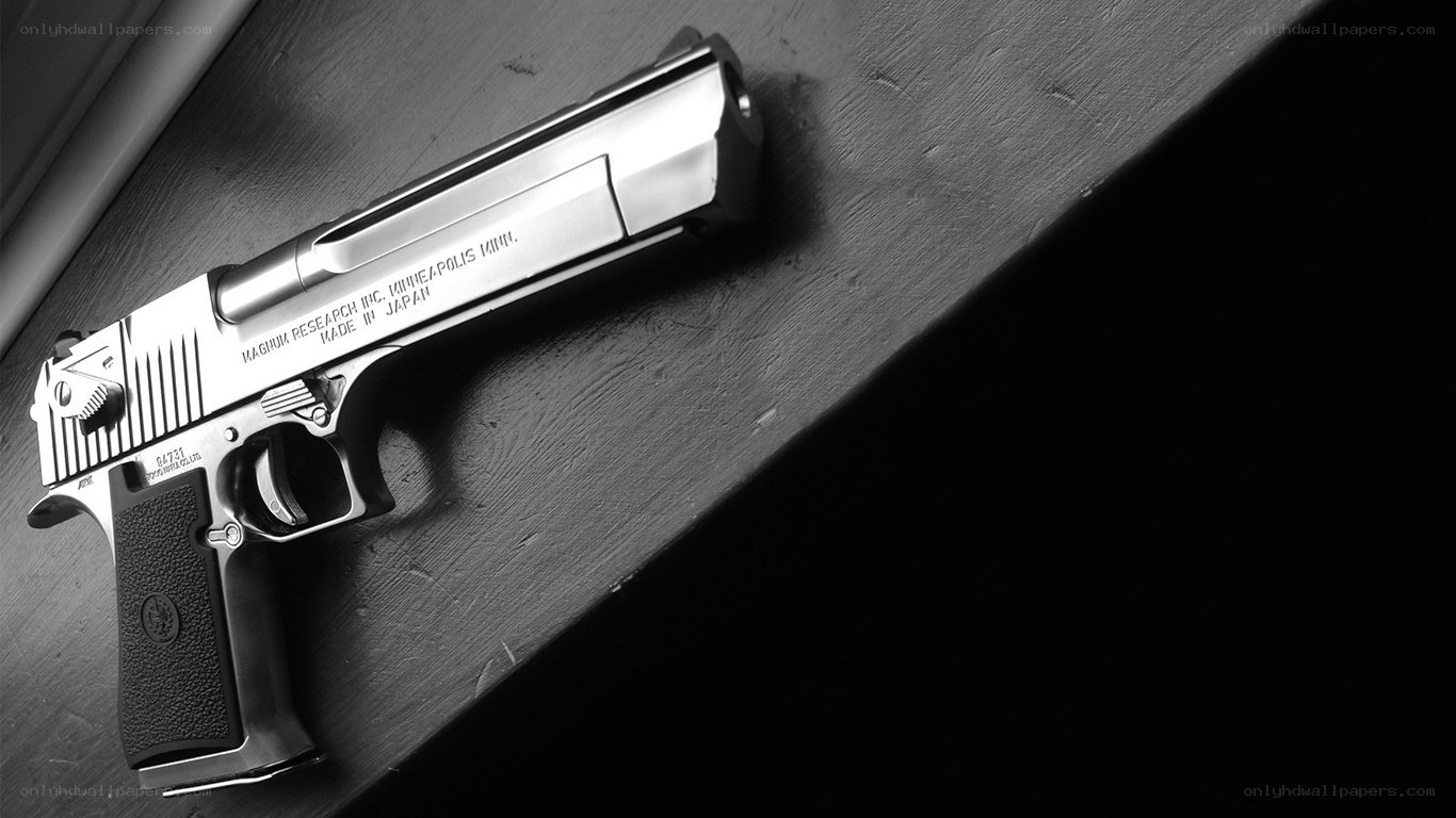 silver handgun on wooden surface