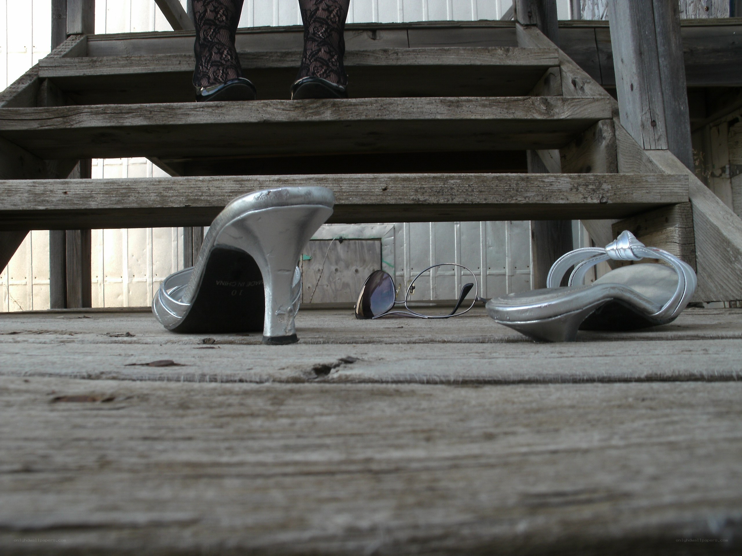Silver heels on wooden steps