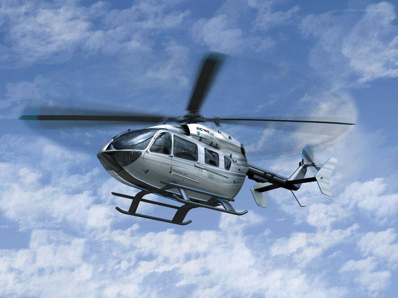 Silver helicopter in flight