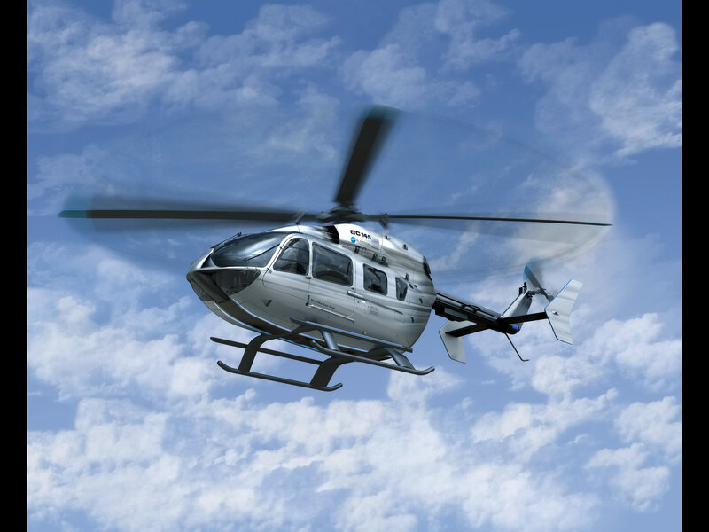 Silver helicopter in flight