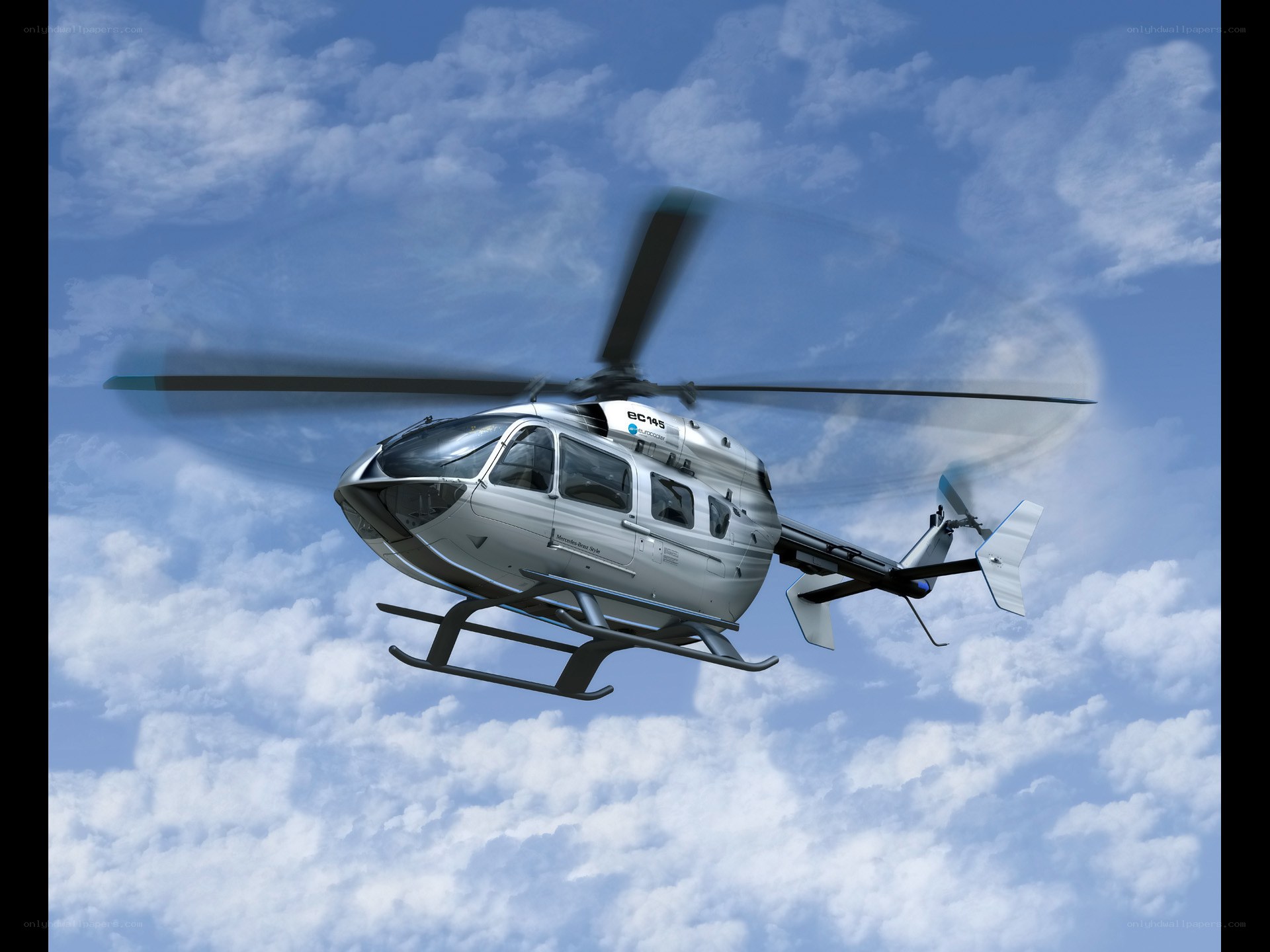Silver helicopter in flight