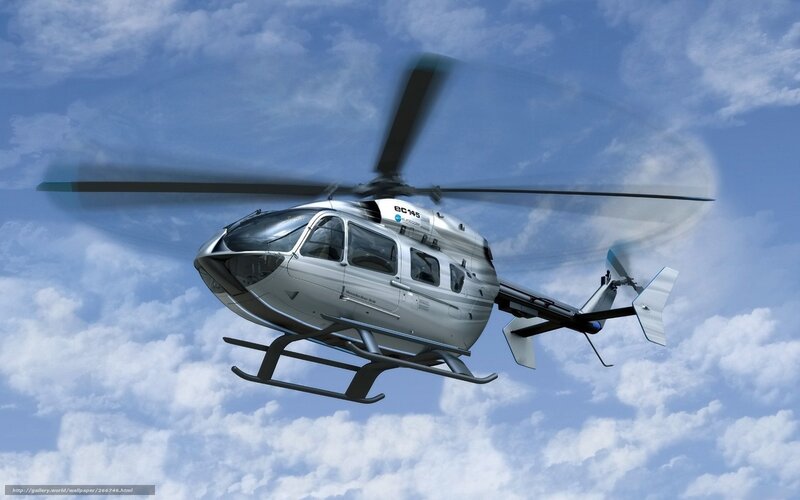 Silver helicopter in flight