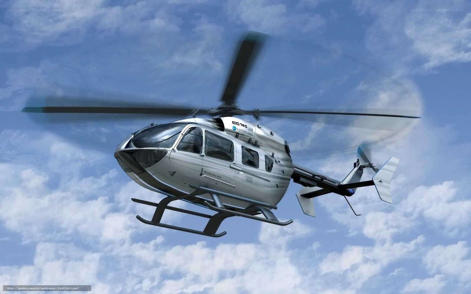 Silver helicopter in flight