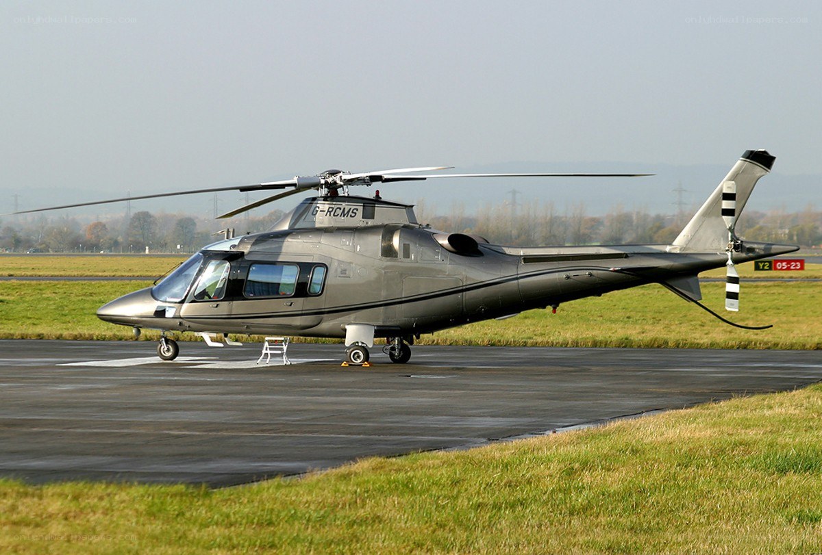 Silver helicopter on tarmac