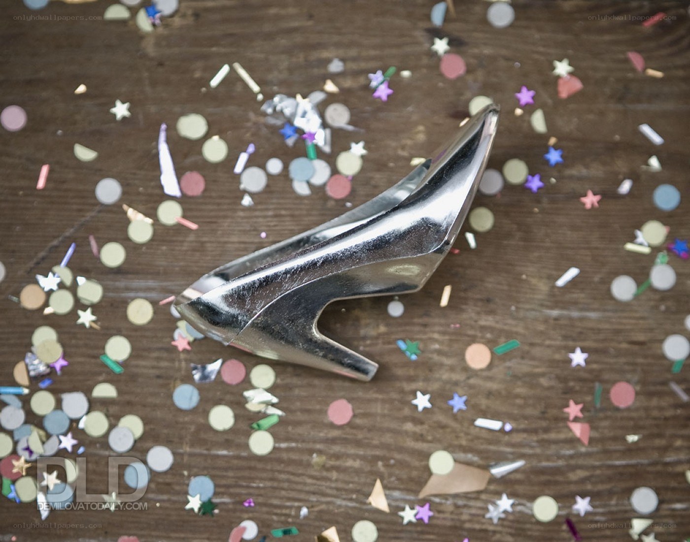 silver high-heeled shoe on confetti