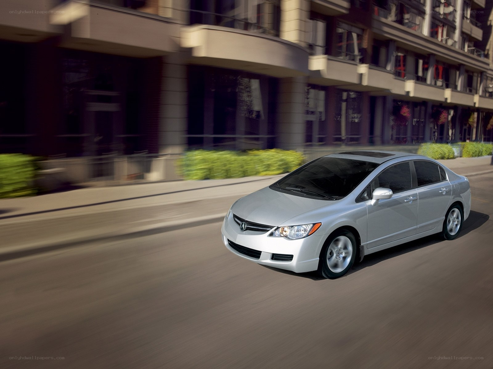 Silver Honda Civic driving on city street
