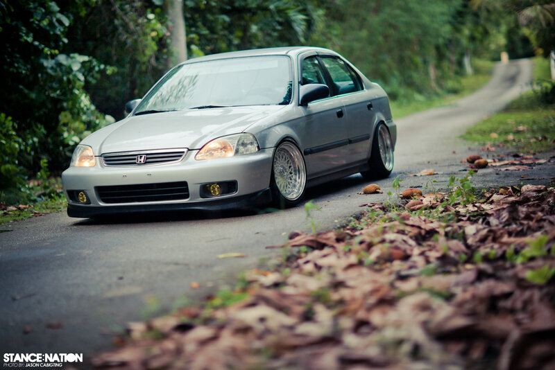 silver honda civic on a forest road