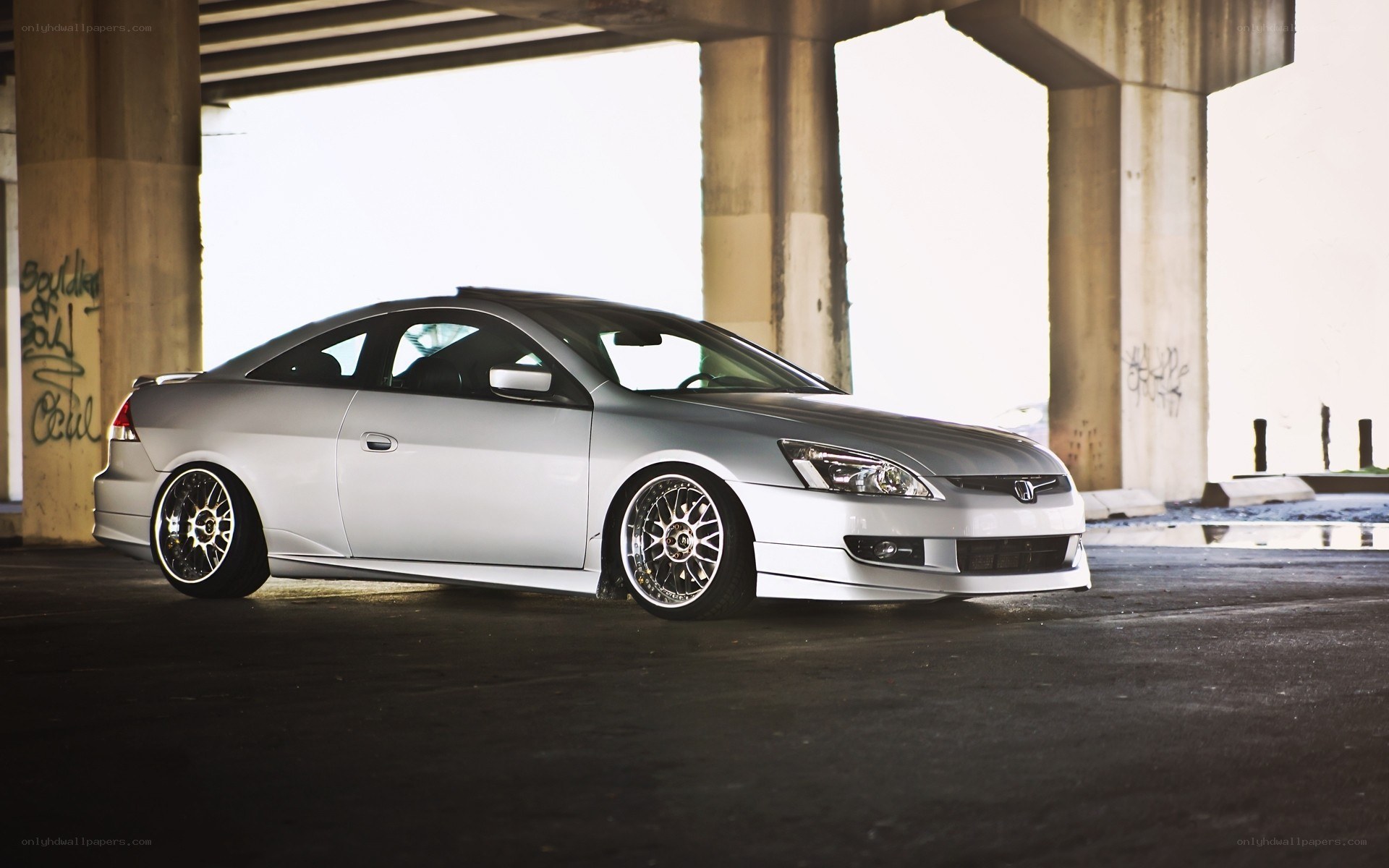 silver honda coupe under bridge