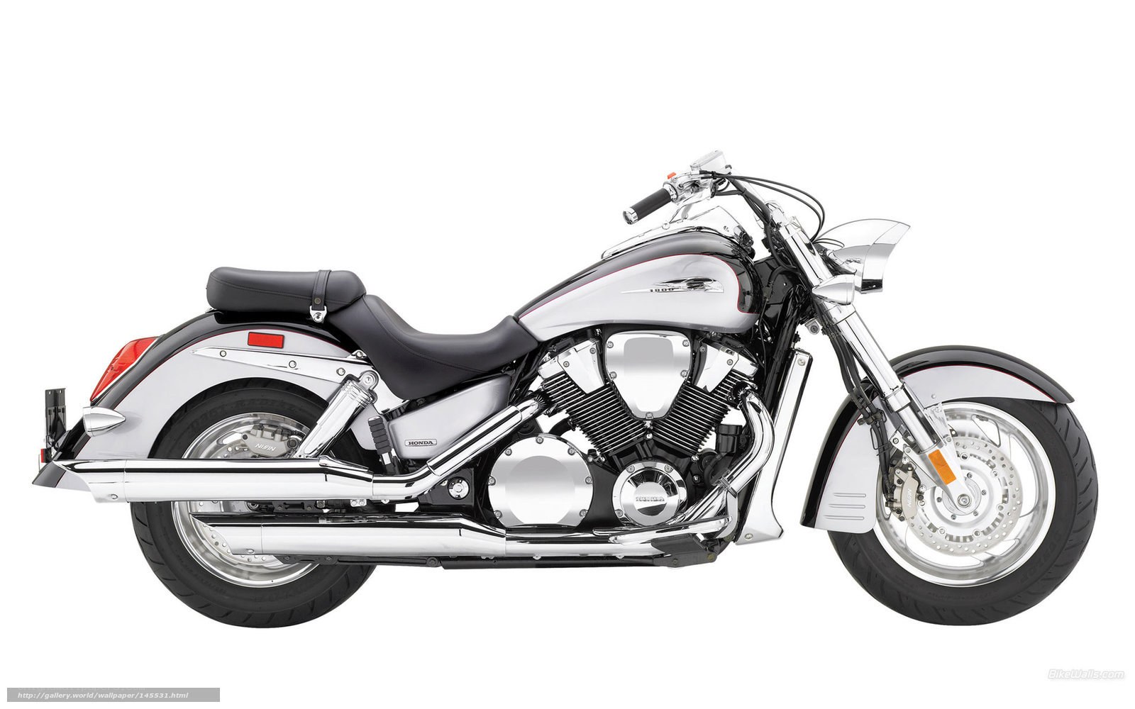 silver Honda cruiser motorcycle