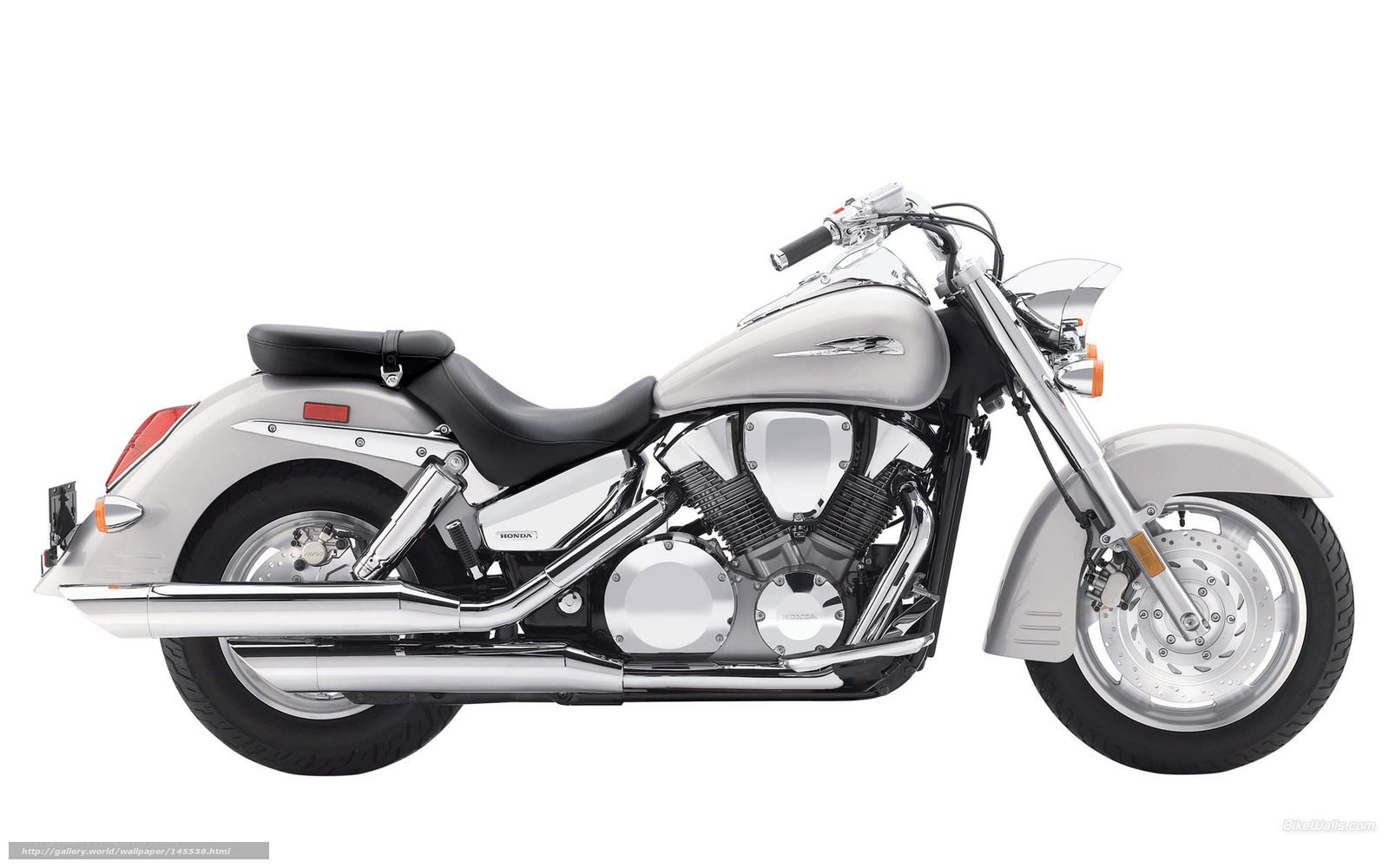 silver Honda cruiser motorcycle