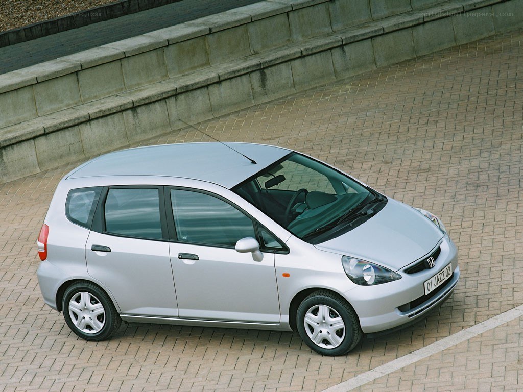 silver honda jazz parked on pavement