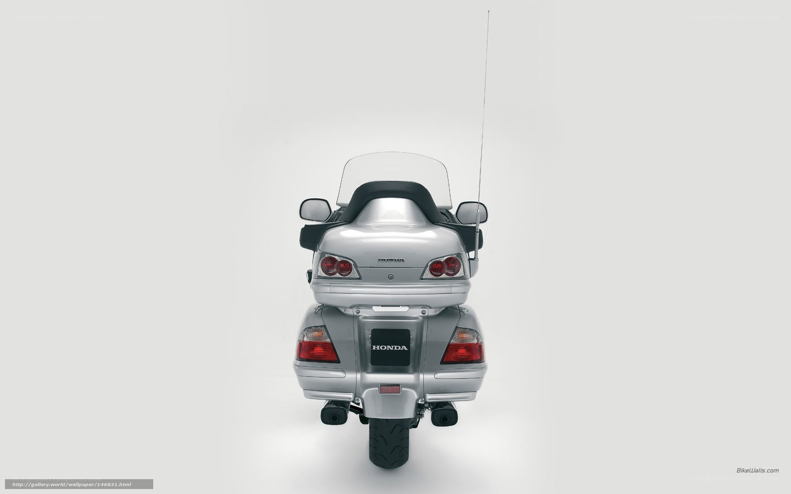 silver honda motorcycle rear view