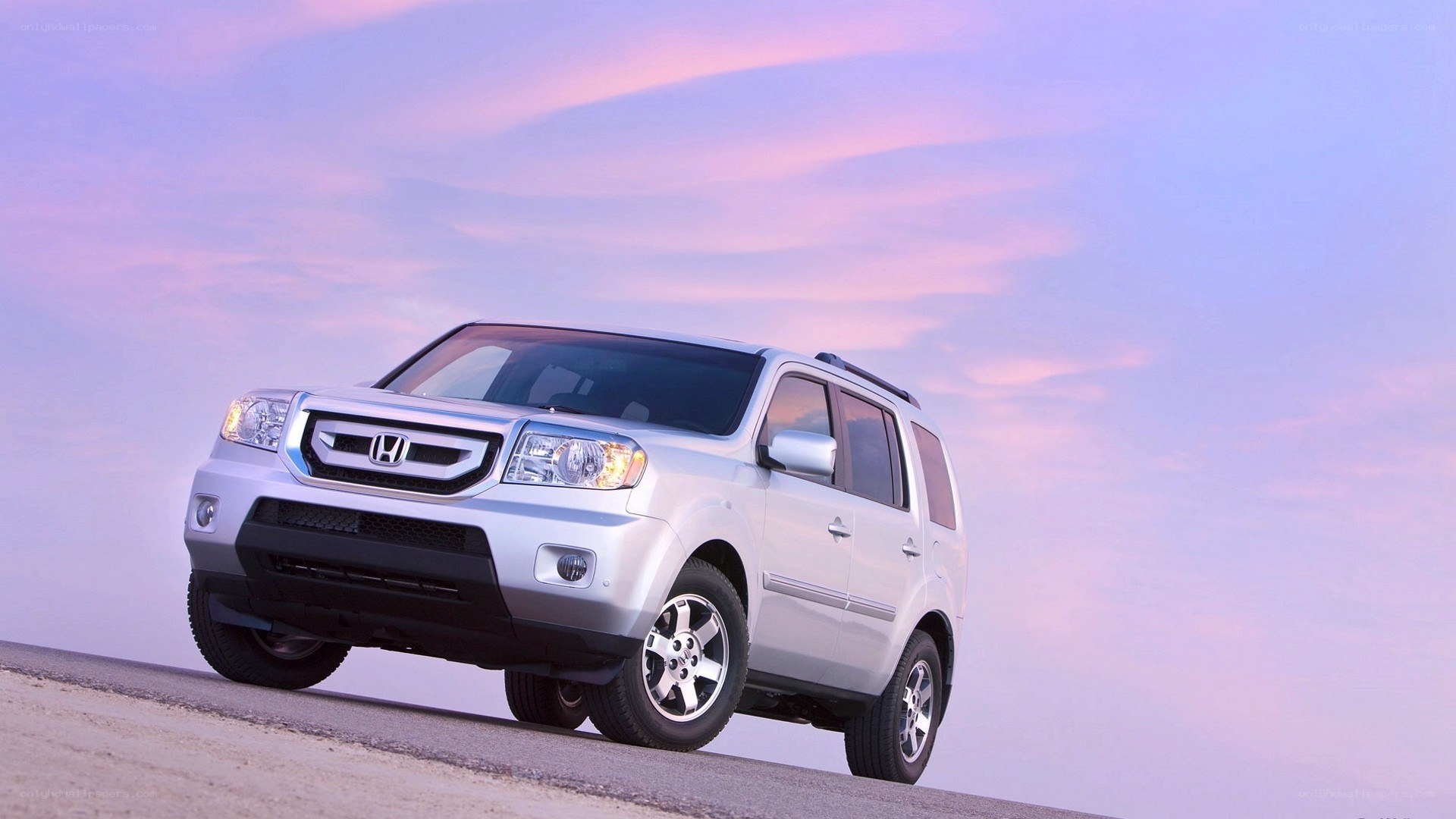 Silver Honda Pilot at sunset
