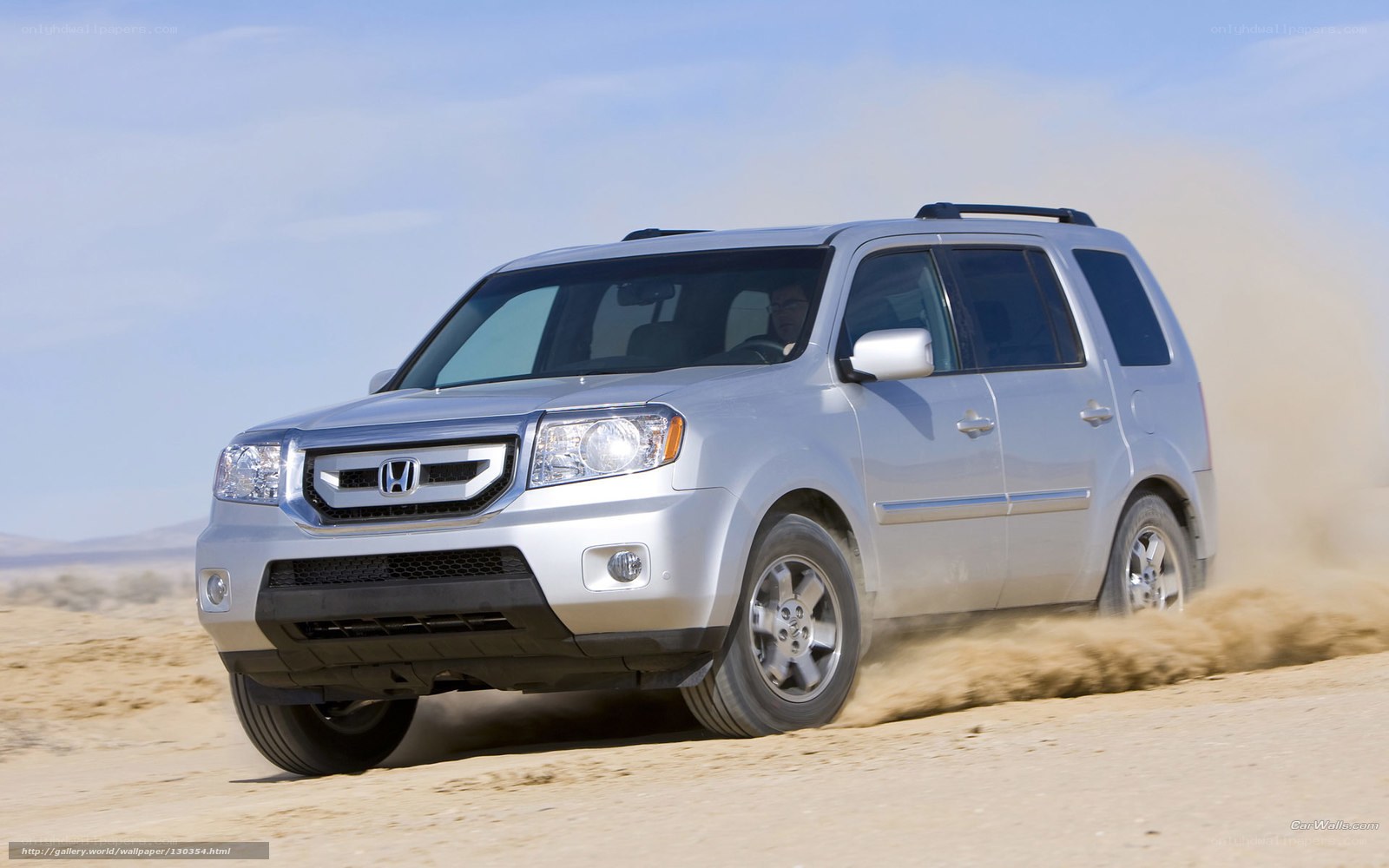 Silver Honda Pilot in desert