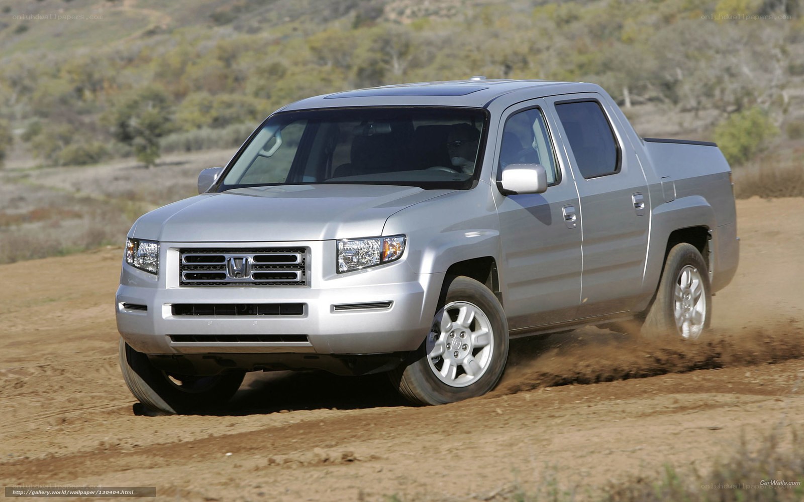 Silver Honda Ridgeline on dirt road