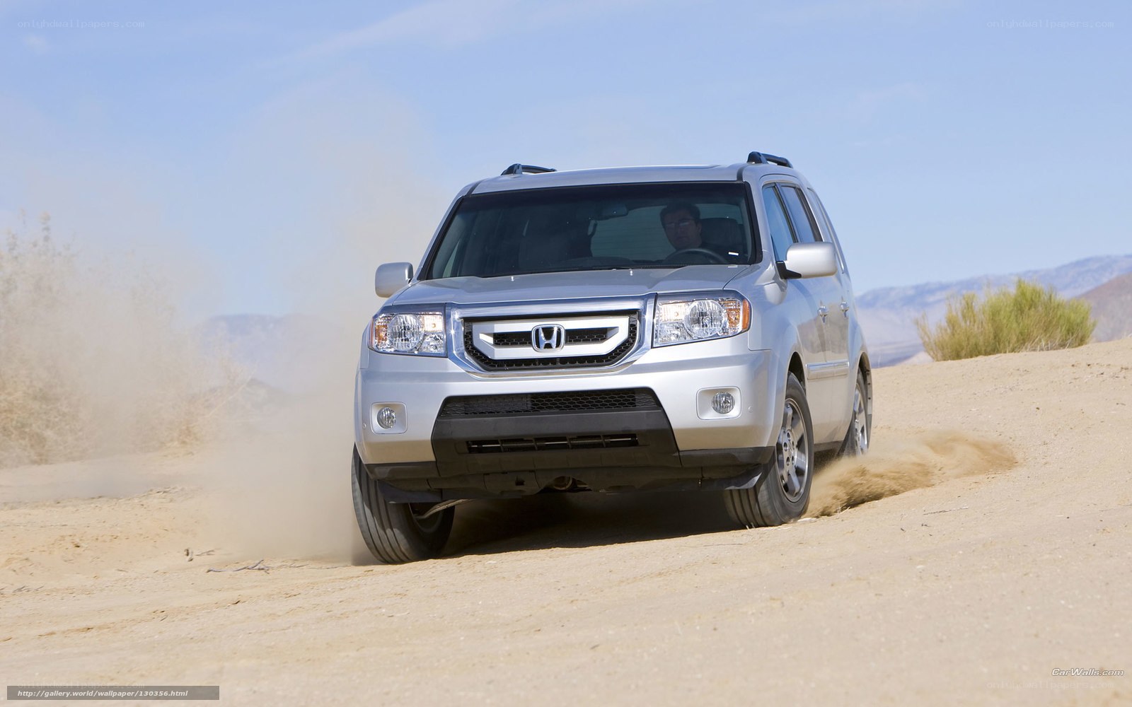 Silver Honda SUV on desert dune