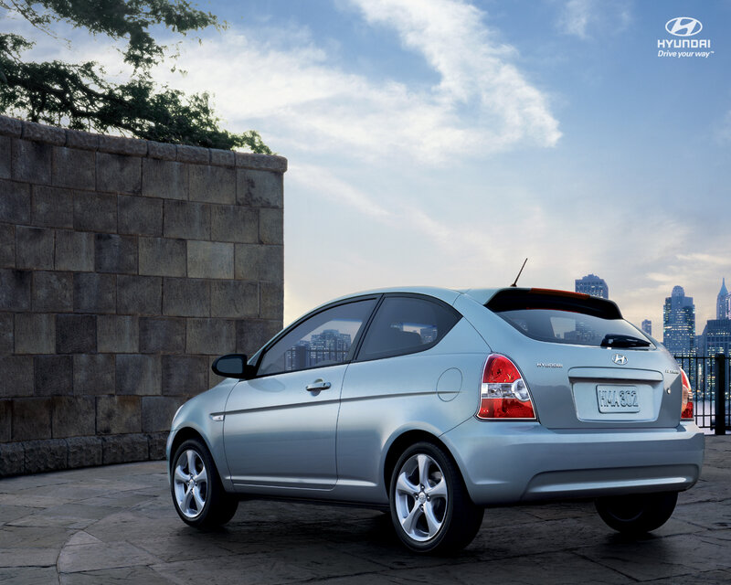 Silver Hyundai Accent parked by city