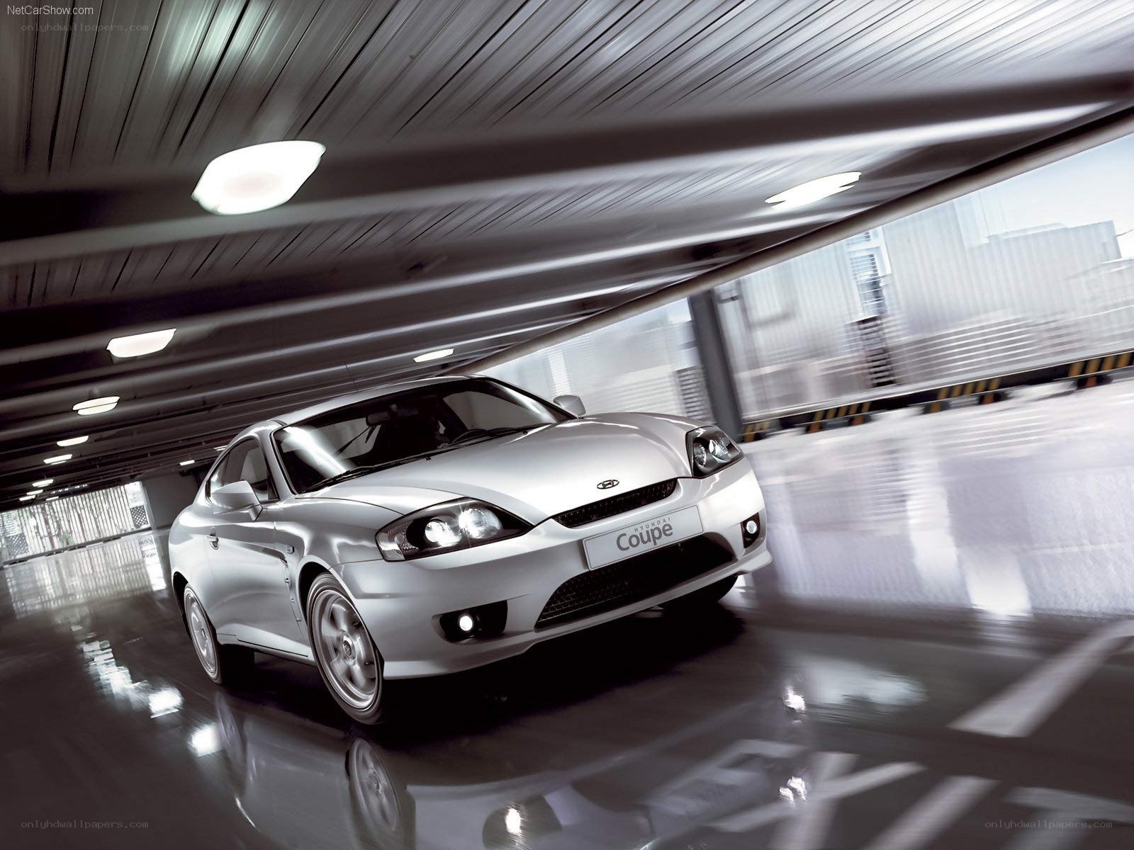 silver hyundai coupe in motion