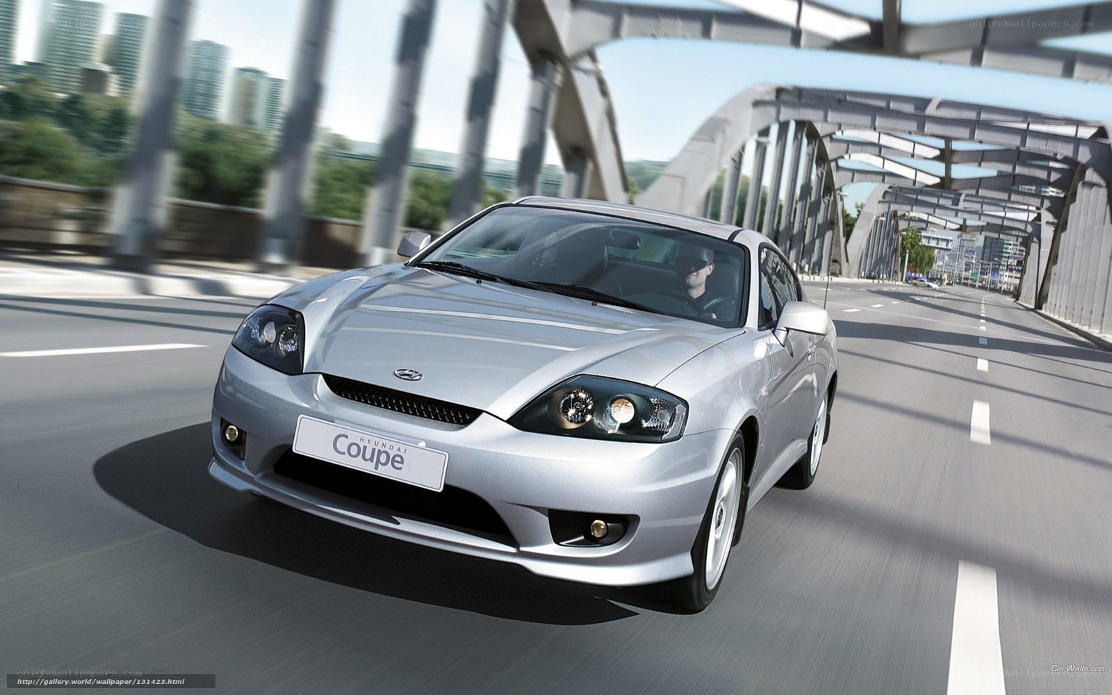 Silver Hyundai Coupe on a bridge