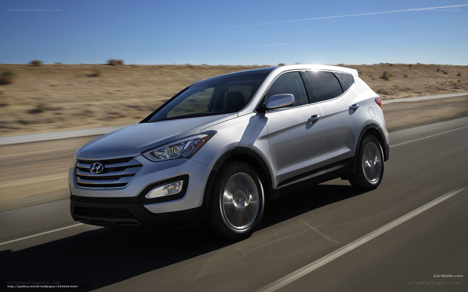 Silver Hyundai Santa Fe driving on road