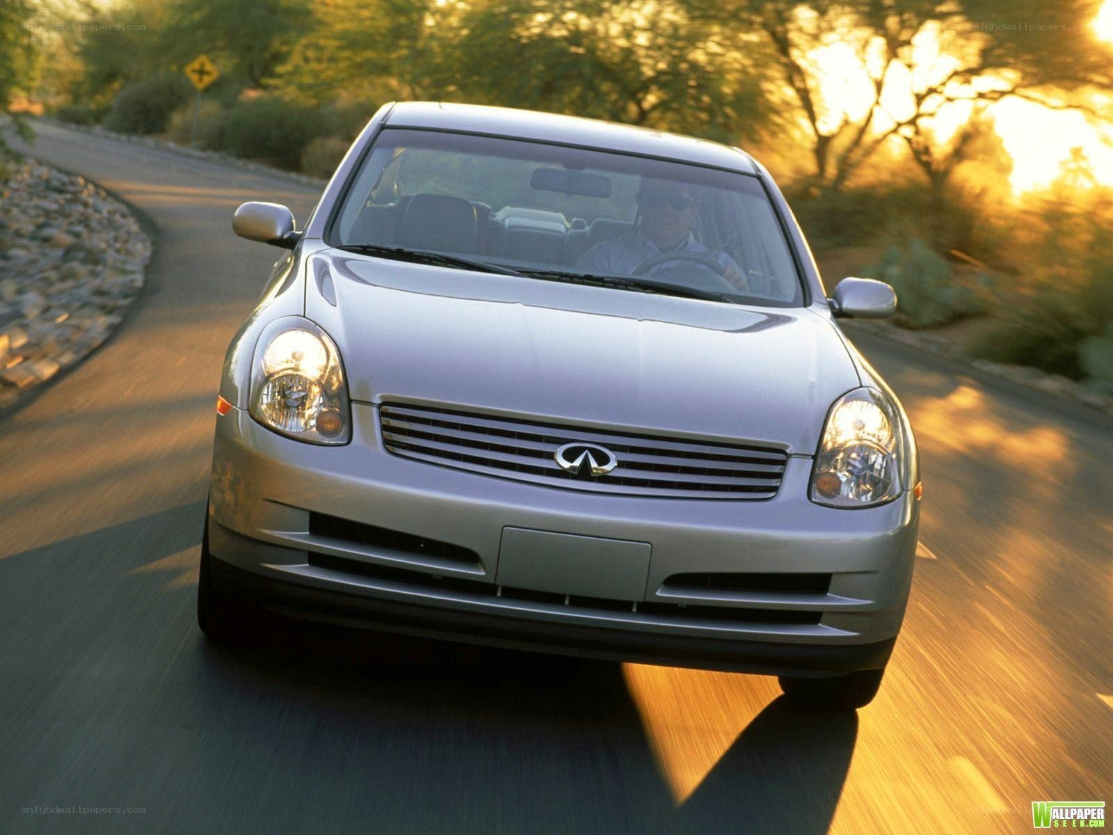 silver infiniti driving on road