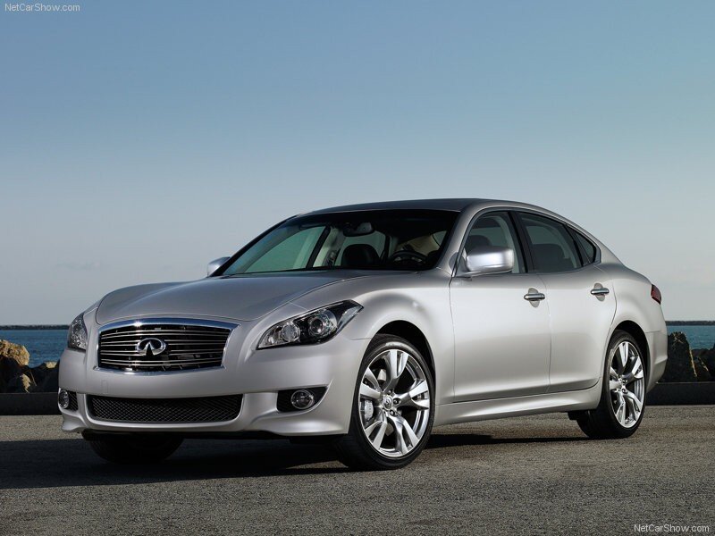 silver infiniti sedan by the sea