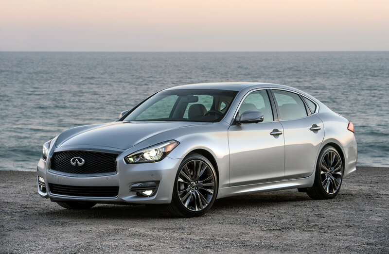 Silver Infiniti sedan by the sea