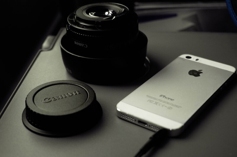 Silver IPhone and Camera Lens