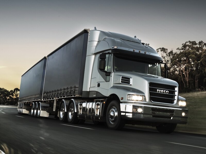 silver Iveco truck on the road