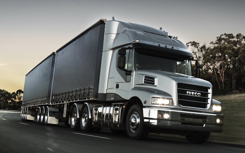 silver Iveco truck on the road