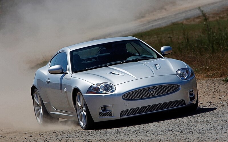 silver jaguar car on dirt road
