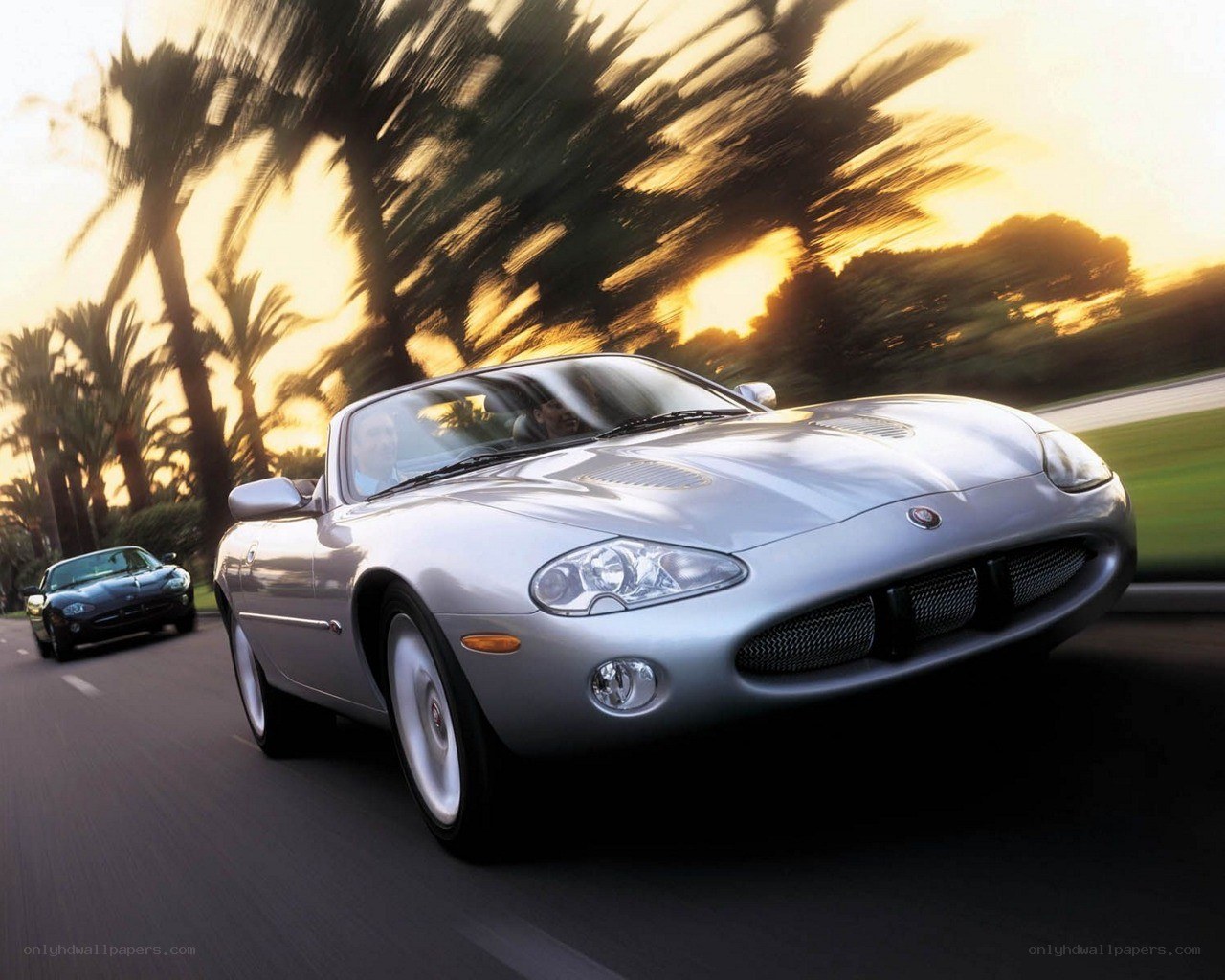 Silver Jaguar convertible in motion