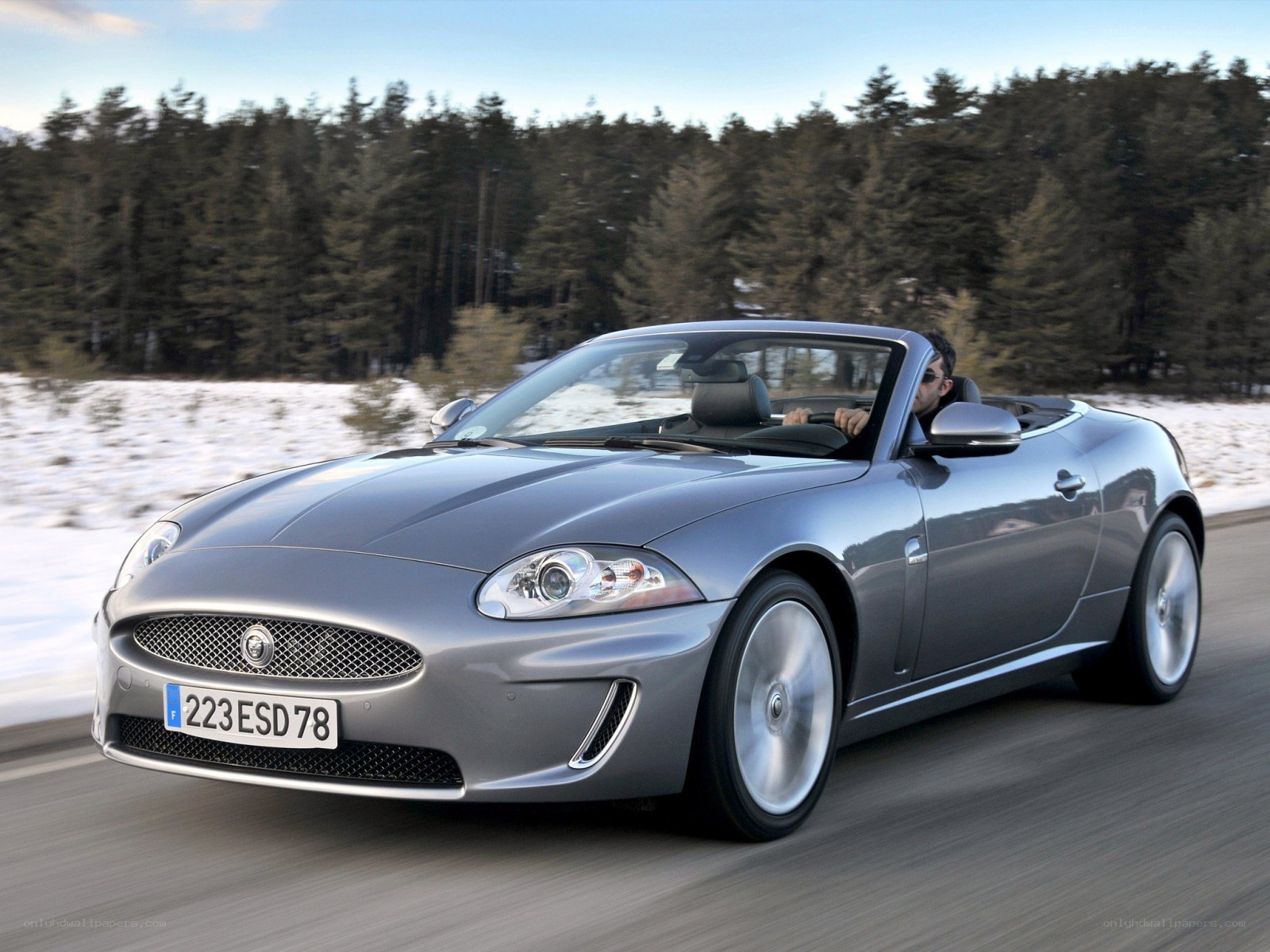 Silver Jaguar convertible on road