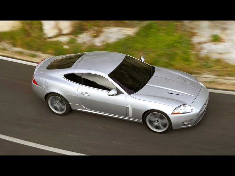 silver jaguar coupe in motion