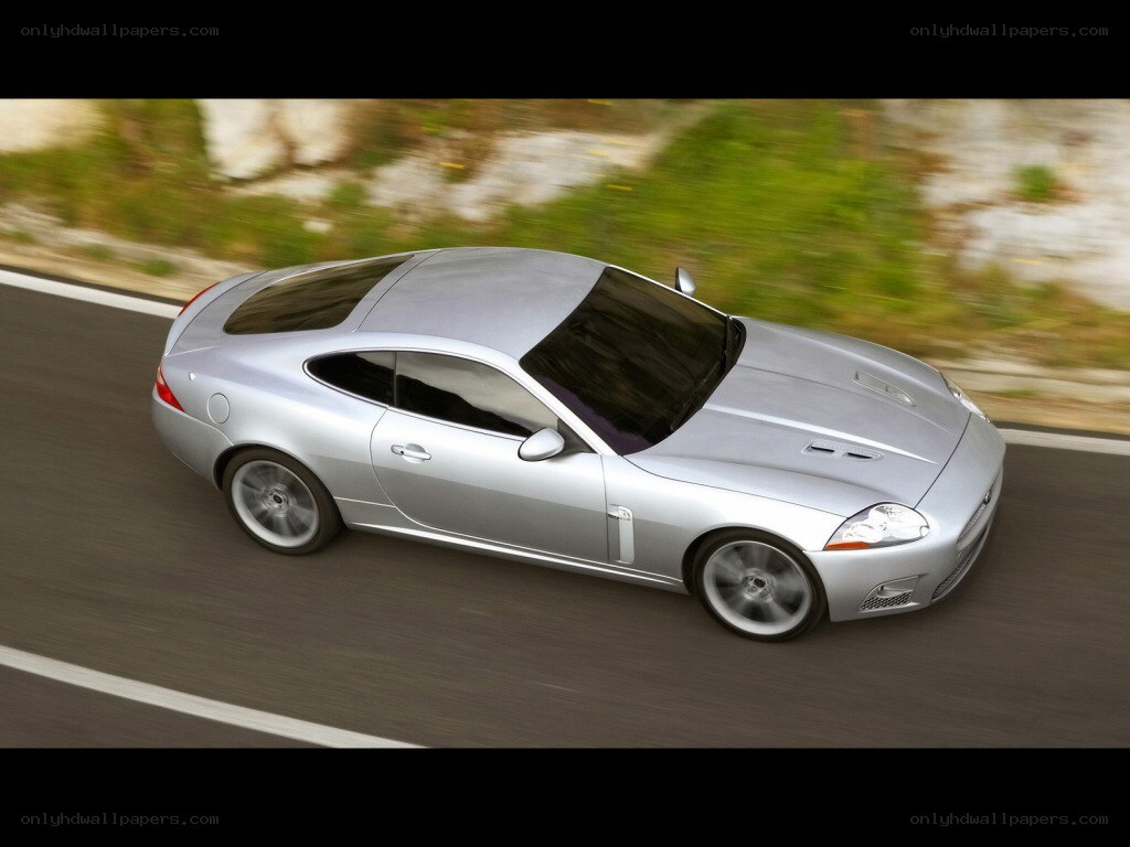 silver jaguar coupe in motion
