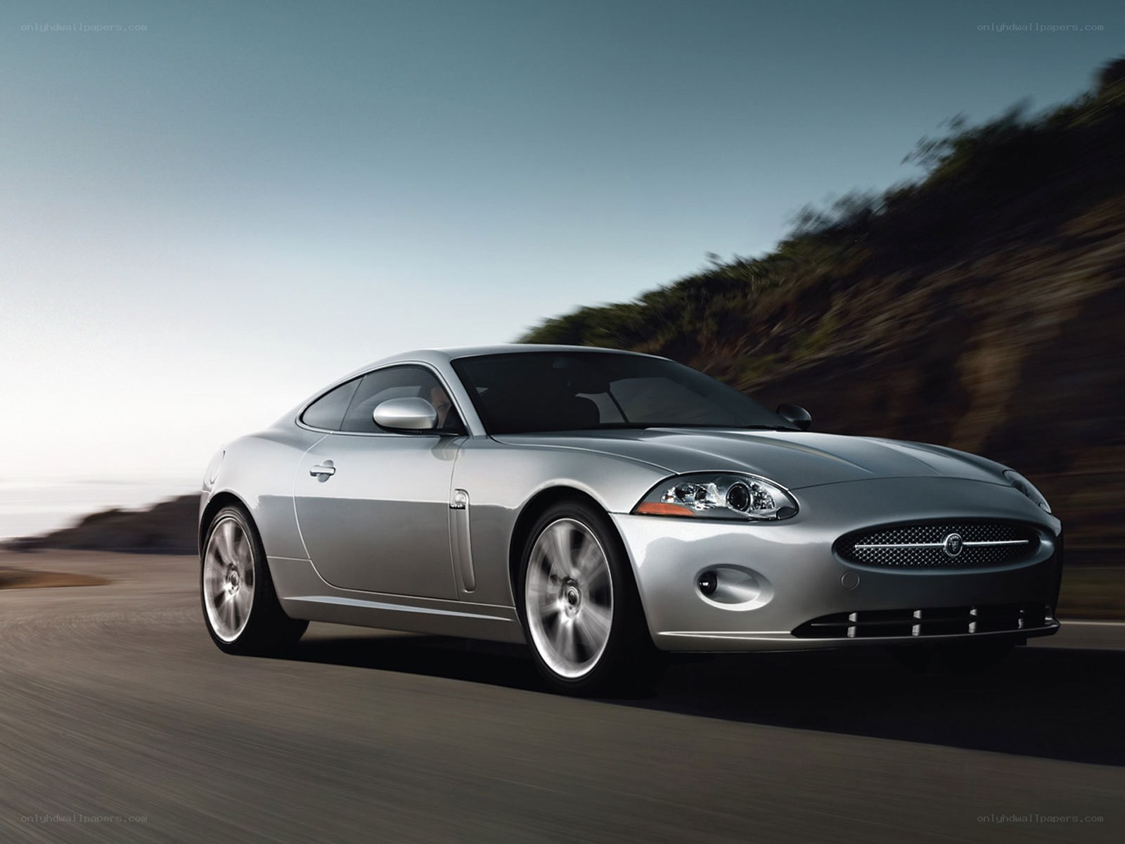 silver jaguar coupe in motion