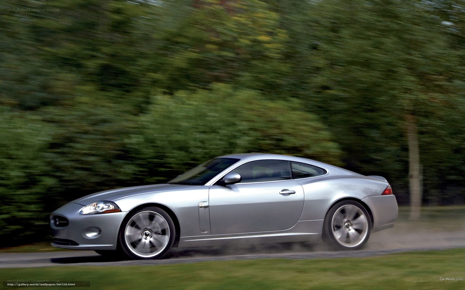 silver jaguar coupe in motion