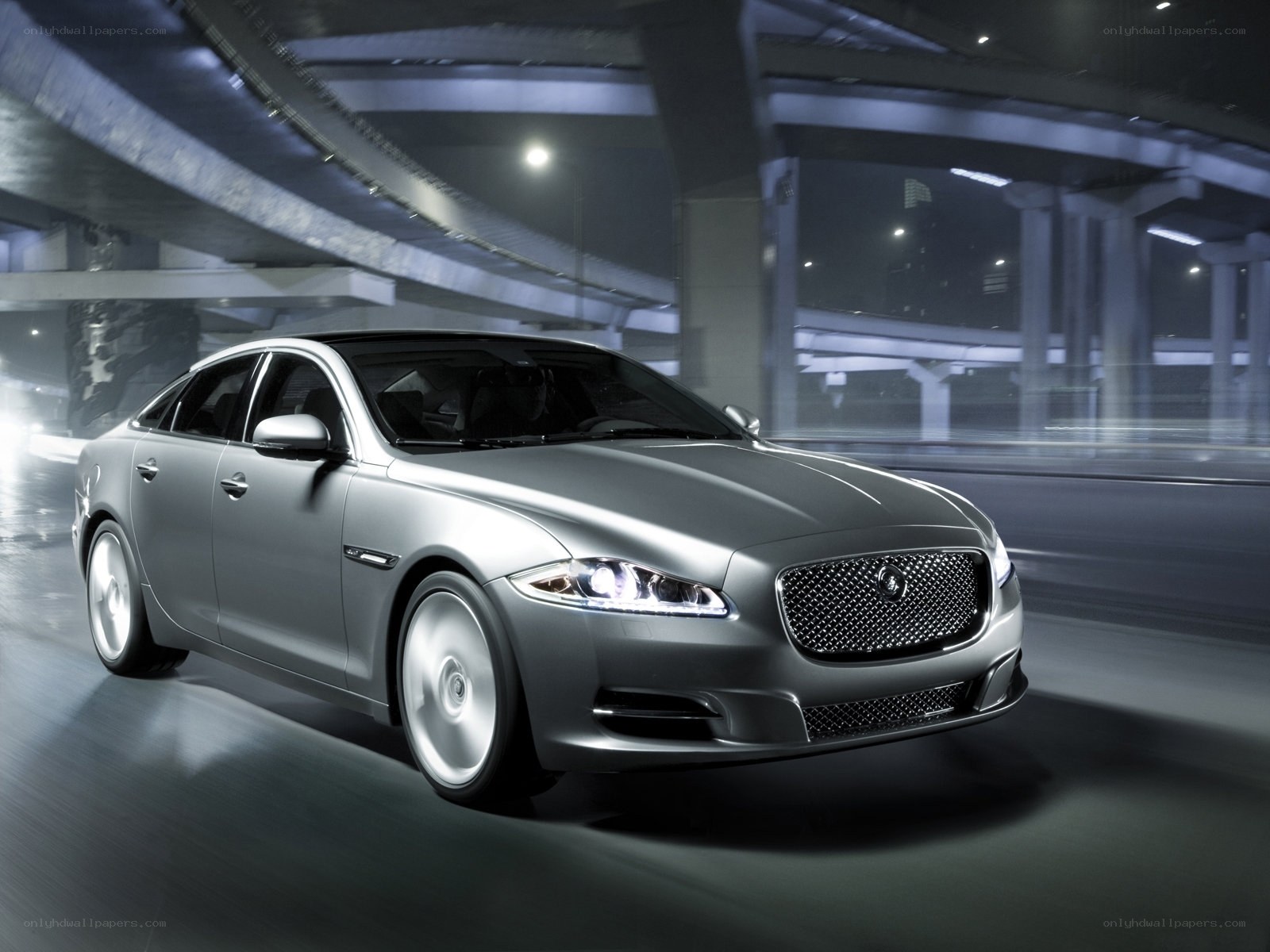 silver jaguar driving at night