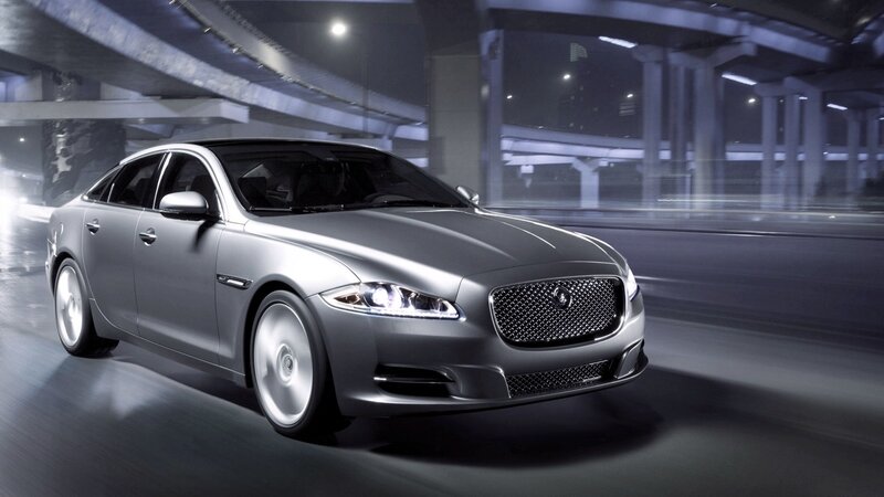 silver jaguar driving at night