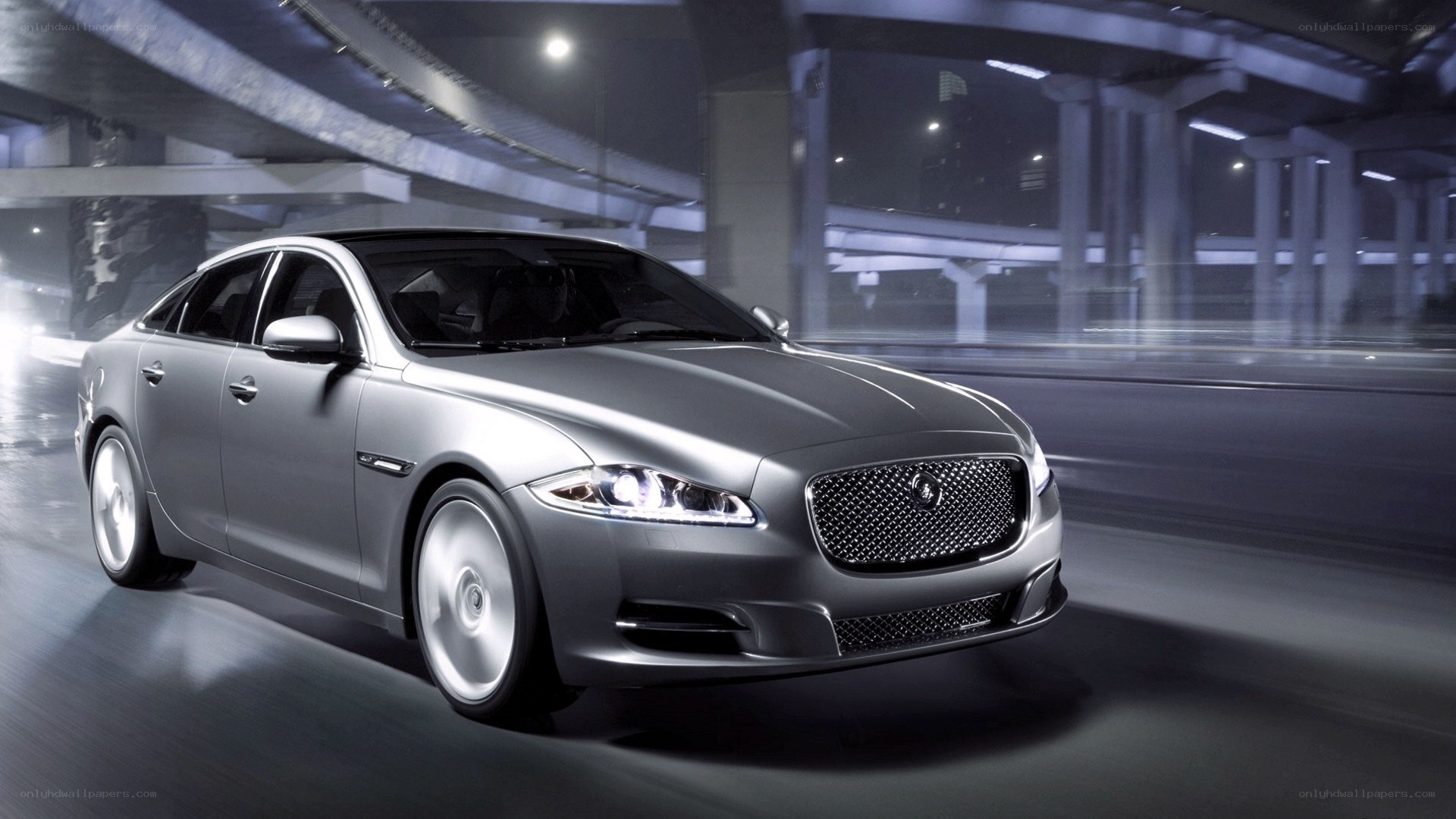 silver jaguar driving at night