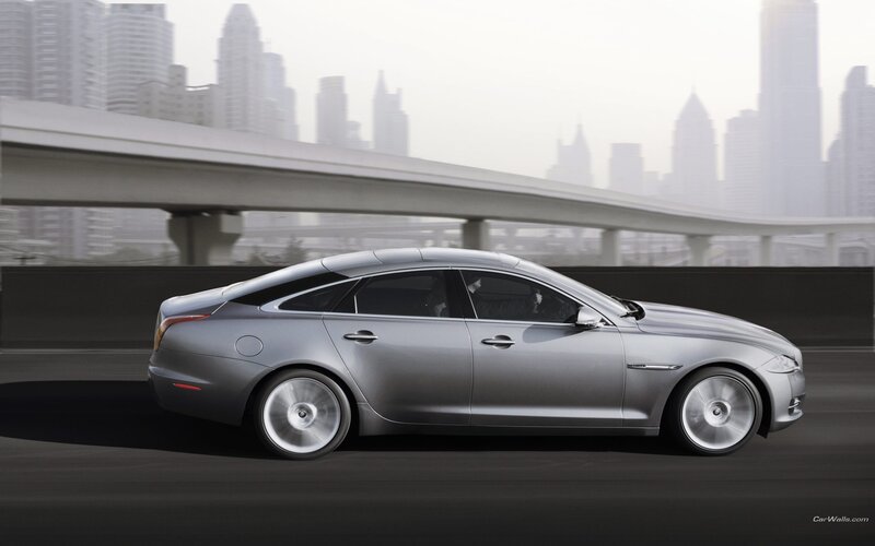 silver jaguar driving in city