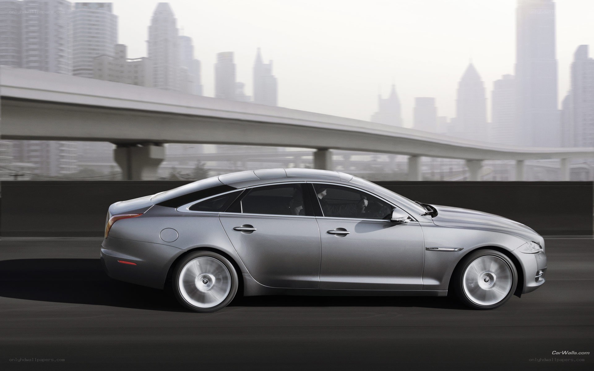 silver jaguar driving in city