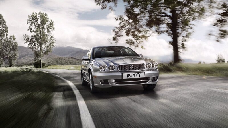 silver jaguar driving on country road